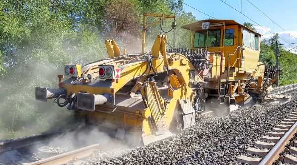 Yellow railroad rail tractor